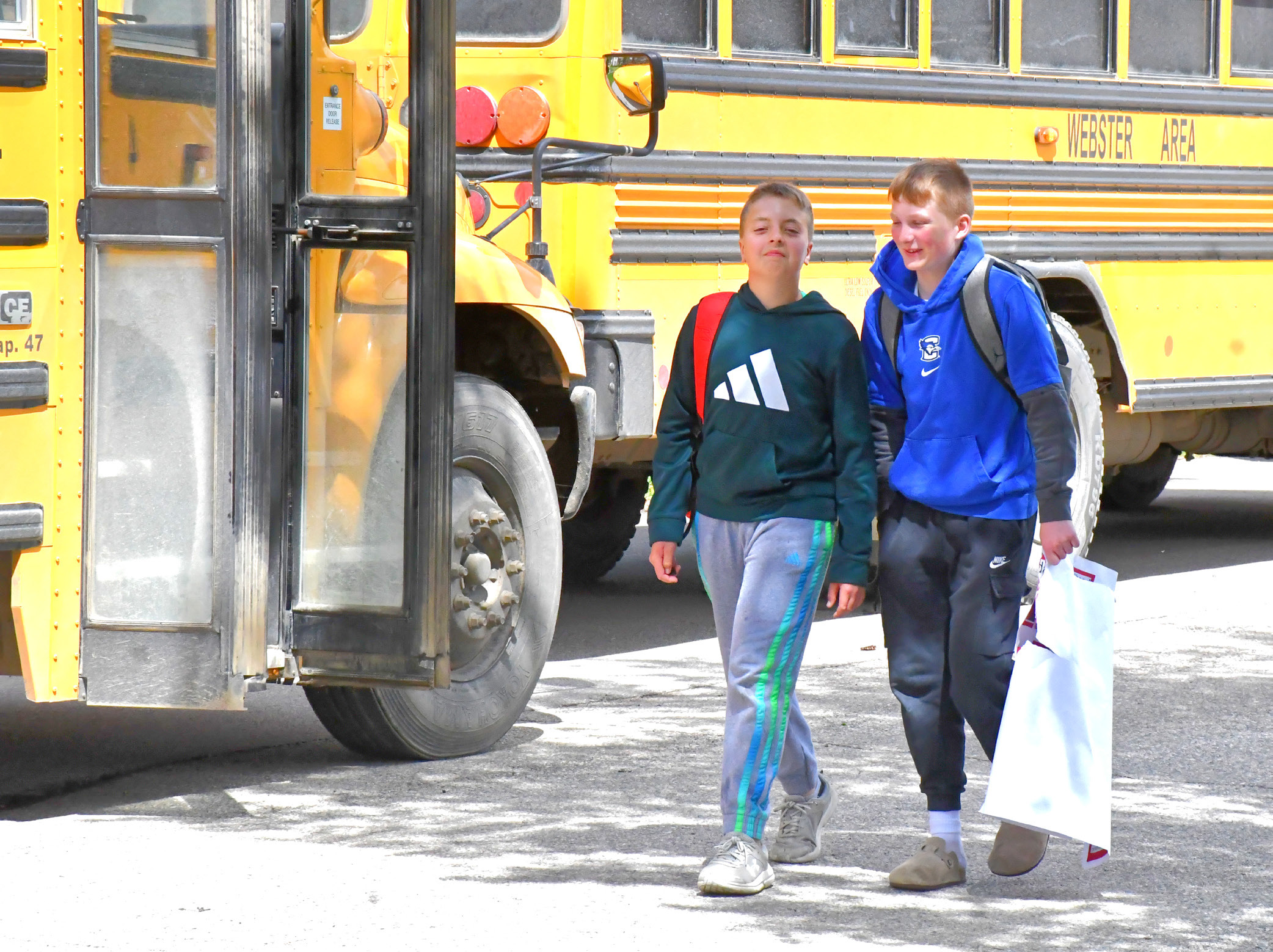 From left, Gunnar Lesnar and Decker Huggett joke and laugh as they walk out of Webster Area School on the final day of school May 18. Reporter &amp; Farmer | Connor Handrahan