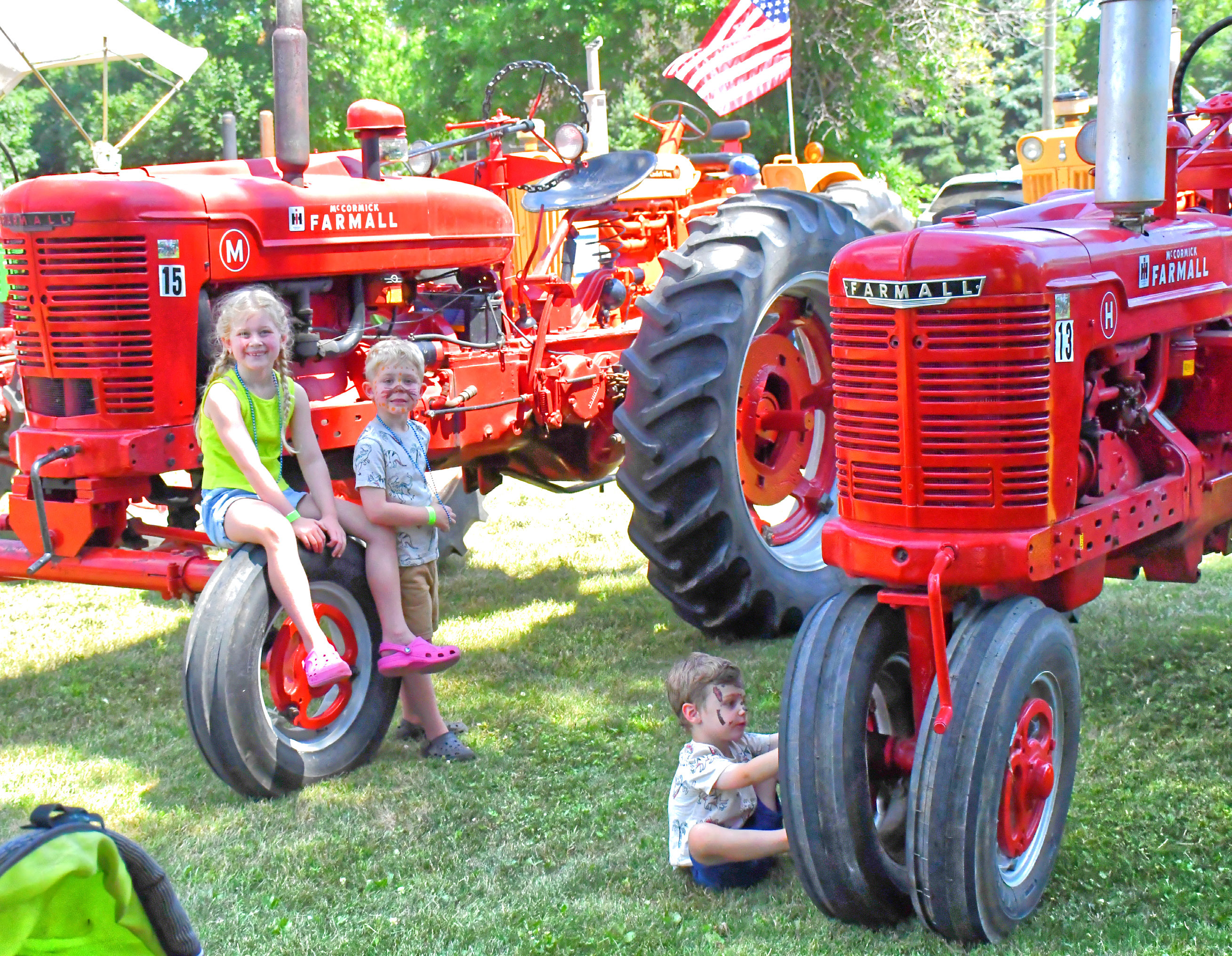 Waubay Fun Fest was July 17-18. WIth Main Street full of festive fun, one entertaining area was where the antique tractors were parked. From left, Peyton and Finn Frank and Tommy Kampa play around the tractors and enjoy seeing the machines close up. See more on 7. Reporter &amp; Farmer | Connor Handrahan
