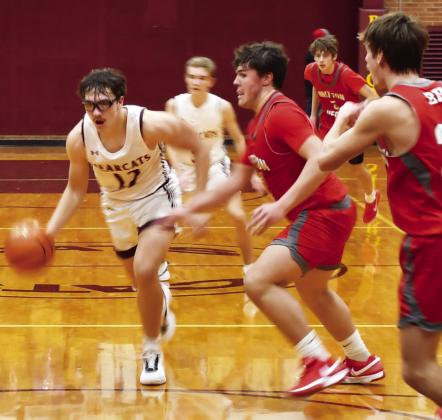 Webster Area Bearcats boys basketball took on the Britton-Hecla Braves Dec. 20 in a contest the Bearcats lost 46-56. Here, Webster Area forward Jeron McCreary (12) drives to the paint with Britton-Hecla defenders Graham Fosness (15) and Daniel Person (20) attempting to impede his route to the basket. Reporter &amp;amp; Farmer | Brenner Cariveau