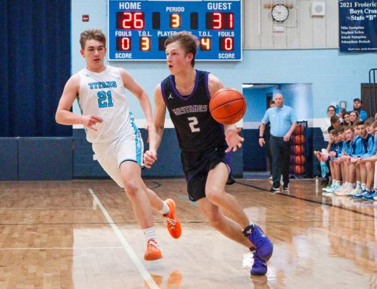 Evan Aker (2) of Waubay/Summit drives past Winston Clark (21) of Leola/Frederick Titans during the Mustangs 56-66 loss March 6 in Frederick. Aker scored four points as Waubay/Summit ended their season with a record of 15-7. Reporter &amp;amp; Farmer | Leyton Beardslee