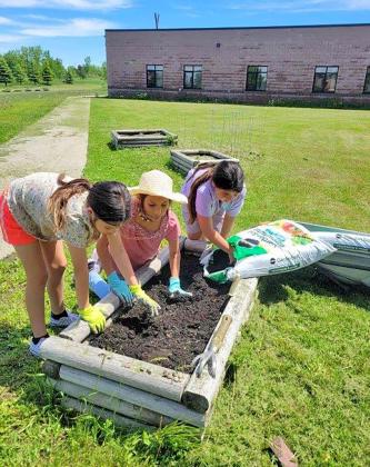 Students of the Toka Nawan Wayawa Tipi (translation: Enemy Swim Day School) Out of School Time program work on planting a garden at the school, located north of Waubay. Pictured from left are Marvalynn Redday, Amelia Simon and Mahpiya Gill. Reporter &amp;amp; Farmer | Subscriber snapshot