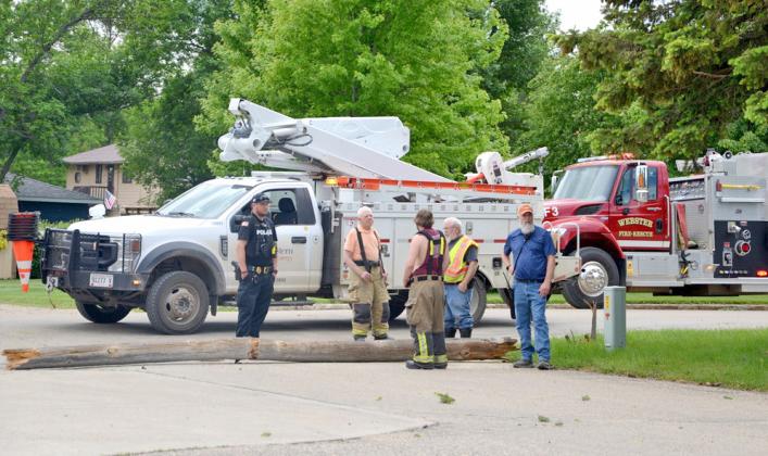 At the scene of where a service truck hooked an overhead cable causing a number of power lines and poles to go down in Webster June 7 stands Webster Police Chief Craig Baumgarn and Webster Volunteer firefighters Fritz Kwasniewski, Eric Kwasniewski, Wes Hoven and Austin Eisenbraun. Reporter &amp;amp; Farmer | Annie Witt