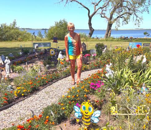 The Angel Memorial Garden comes to life each spring along the shore of Blue Dog Lake, where Waubay community members led by Brenda Holscher, pictured center, plant flowers and perennials to remember loved ones. Reporter &amp; Farmer | Timothy Gibson