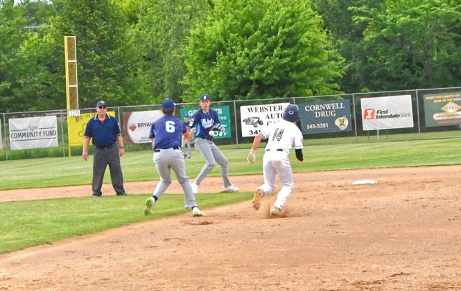 Post 40 second baseman Jack Shoemaker throws the ball to shortstop Sheldon Schmieg to set up a double play at second and first during the Post 40 vs. Rattlers game June 20 during the Ashley Charron Wood Bat Tournament. Reporter &amp;amp; Farmer | Connor Handrahan