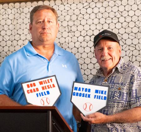 Baseball complex coordinator and Webster Legion baseball coach Chad Hesla and Webster Mayor Mike Grosek received plaques Aug. 16 for baseball fields which will be named after them at Veteran’s Memorial Sports Complex in Webster. Hesla has been coaching baseball for 25 years and spent significant time fundraising and planning for the complex. Grosek coached for 20 years starting at age 17 and was mayor when the city purchased the land for the site in 2000. Reporter &amp;amp; Farmer | Leyton Beardslee