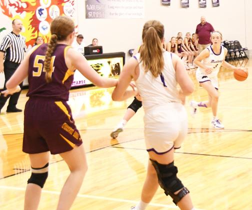 Waubay-Summit Mustangs hosted Webster Area Bearcats Dec. 10 in their season opener. The Mustangs prevailed in overtime 50-45. Here, Waubay-Summit’s Faith Larson (3) dribbles the ball inside the arch while her teammate Peyton Rumpza (1) attempts to clear out space from Webster Area Bearcat Karli Sannes (54). Reporter &amp;amp; Farmer | Robert Dulitz