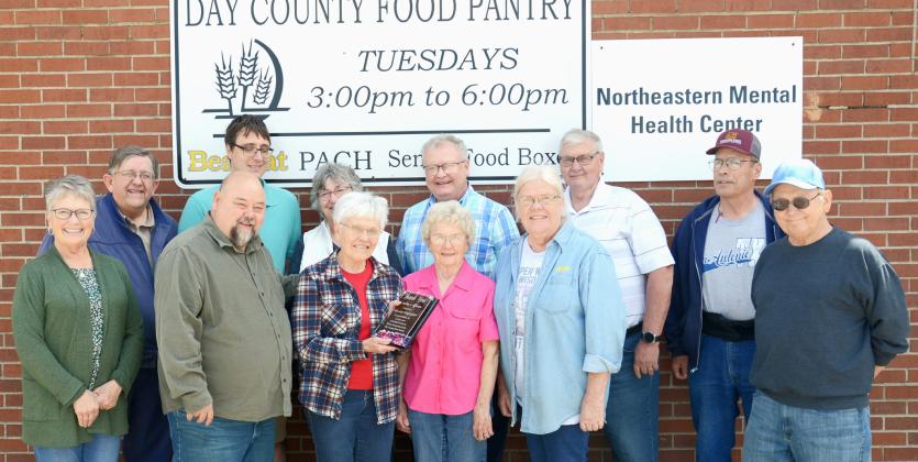 On her final day of volunteering at the Day County Food Pantry May 28, Louise Grajczyk was surrounded by coworkers-turned-friends who included fellow volunteers and area pastors. From left in back is Mike McCarlson, Tim Martin, Mary Wagner, Mike DeKraai, Lynn Lutz and Rick Hanson; from left in front is Susie Hanson, Clark Audiss, Louise Grajczyk, Carol Richardt, Winneva Jacobs and Denny Dugaard. Reporter &amp;amp; Farmer | Annie Witt