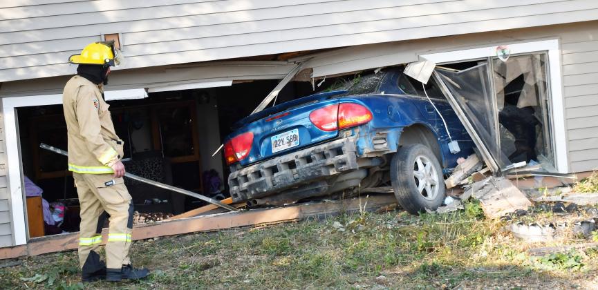 A fireman looks on towards the destruction after a car crashed into a Bristol apartment’s living room Oct. 9. According to Bristol Fire Chief Preston Hansmeier, the driver sustained the only injury during the incident. No cause has been found, Hansmeier said. Reporter &amp;amp; Farmer | Brenner Cariveau