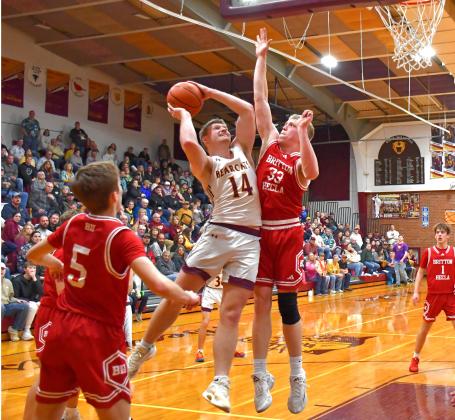 Matthew Mount (14) of Webster Area goes up for a basket while being guarded by Jaxon Zuehlke (33) of Britton-Hecla Braves during the Bearcats 78-57 region playoff win in Webster March 6. Mount tallied 18 points, five rebounds and five assists to help advance Webster to the SoDak 16. Reporter &amp;amp; Farmer | Connor Handrahan