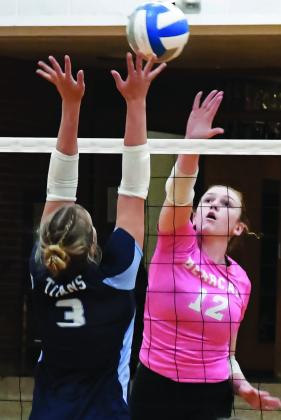 Karli Sannes (12) of Webster Area hits the ball over Kalyce Achen (3) of Leola/Frederick Area during the Bearcats 3-0 match win over the Titans Oct. 6 in Webster. Set scores for the match were 25-11, 25-21 and 25-16. Reporter &amp;amp; Farmer | Amanda Dulitz