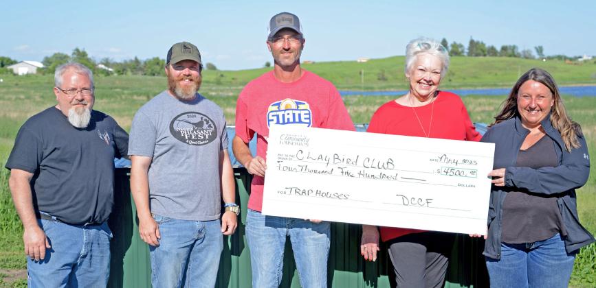 Members of the Claybird Club received a $4,500 check from Day County Community Foundation. Those funds were used to secure new trap houses at the Webster shooting facility. Pictured from left are club members Eric Kwasniewski, Nick Markl and Nick Kvernevig receiving a check from WCCF board members Rita Johnson and Amanda Dohn. Reporter &amp;amp; Farmer | Amanda Dulitz