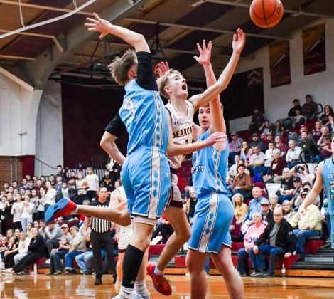 Seth Lesnar of Webster Area tosses up a shot between two Leola/Frederick defenders during the Bearcats 75-64 victory over the Titans Feb. 14 at Webster Armory. Lesnar finished the game with eight points, five rebounds and two assists. Reporter &amp;amp; Farmer | Leyton Beardslee