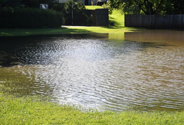 A lot on the corner of W. Eighth Ave. and W. Seventh St. in Webster was flooded after an overnight storm rolled through Aug. 14, bringing an estimated 3.5 inches in Webster. Reporter &amp;amp; Farmer | Leyton Beardslee
