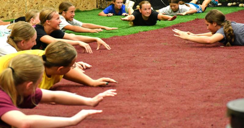 A performance camp was hosted for boys and girls July 27-30 at the baseball’s indoor complex. TLC Physical Therapy put on this camp as a way for kids to get more excercise and learn college level training techniques. “It’s been so fun so far, everyone seems to love it,” said Ayla Bloom. From left, Bloom, McKenley Curran, Harper Olson, Portlyn Johnson, Lydia Petersek, Embry Duenwald, Elin Voss and Ryan Johnson hold the “superman” pose. Reporter &amp; Farmer | Connor Handrahan