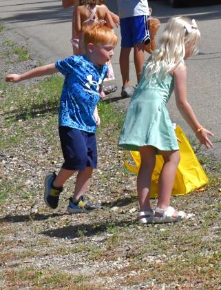 McCoy Larson and Naomi Larson can be seen enjoying the candy thrown out by members of the parade during Waubay Fun Fest July 17-18.