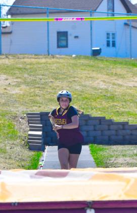 Emily Acree eyes her target midway through an attempt to leap over the bar in Webster April 21. Reporter &amp;amp; Farmer | Leyton Beardslee