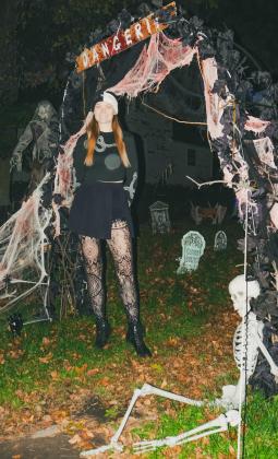 Halloween enthusiast Jenaica Hunt stands in front of her decorations Oct. 22 in Webster. Hunt, a lifelong Webster resident, said this is her first year getting to decorate her own house for the holiday. Reporter &amp;amp; Farmer | Leyton Beardslee