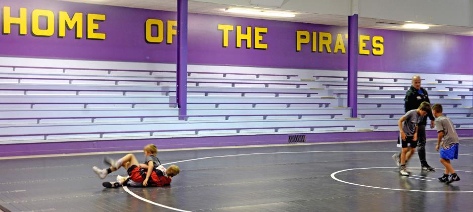 Some Sniper Wrestling Academy wrestlers practice in the former Bristol School gym. Pictured from left are Cruz Praszincki and Oliver Umlauf working on technique during a practice while Braxten Sombke and Wesley Storts get situated with coach Chad Umlauf watching. Reporter &amp;amp; Farmer | Annie Witt