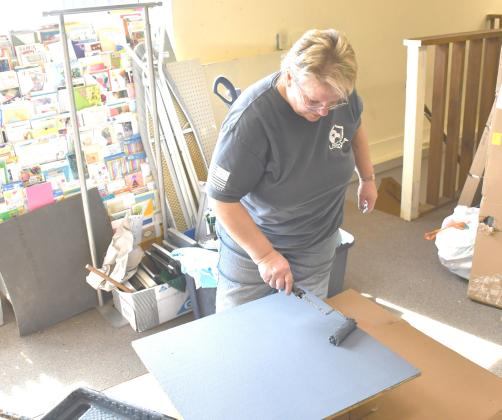 Needs Anonymous thrift store is undergoing renovations with the intention of re-opening March 29. Here, volun-teer Cathy Witzke helps paint shelving for the store March 12. Reporter &amp;amp; Farmer | Brenner Cariveau