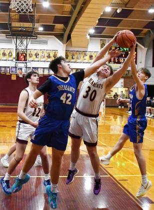 Webster Area Bearcats had their last home game of the season against Redfield and secured an 71-41 victory Feb. 22. Here, Thomas Kuecker (30) attempts to grab the rebound between Redfield’s Ethan Falk (42) and Isaac Banister (22) while Jack Shoemaker (42) rushes towards the paint. Reporter &amp;amp; Farmer | Brenner Cariveau