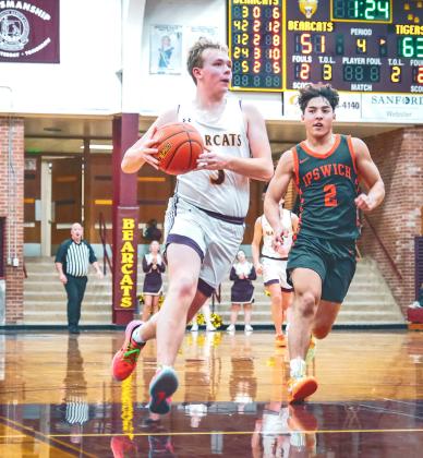 Sheldon Schmieg (5) of Webster Area looks to score a break-away layup during the Bearcats 62-65 loss to Ipswich Tigers Dec. 20 in Webster. Schmieg aided the Bearcats effort making two of his three attempts from beyond the arc. Reporter &amp;amp; Farmer | Leyton Beardslee