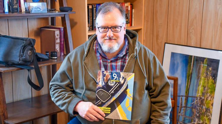 Greg Abbott of Lily, pictured in his home Dec. 10 is the chief editor of the Saab Club of North America’s quarterly magazine. Abbott said he purchased his first of many Saab cars while in college and has been involved with the club since 2006. Reporter &amp;amp; Farmer | Leyton Beardslee