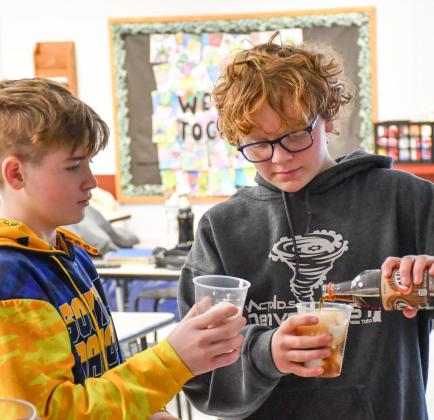 Webster Area eighth grade students, from left, Harley Valley and Casen Fish make root beer floats Feb. 2 at Webster Area Middle School as the class reward for having the highest average attendance for the month of January. Principal Craig Case said this is one change the school has made to help incentivize higher attendance among elementary and middle school students. Reporter &amp;amp; Farmer | Leyton Beardslee