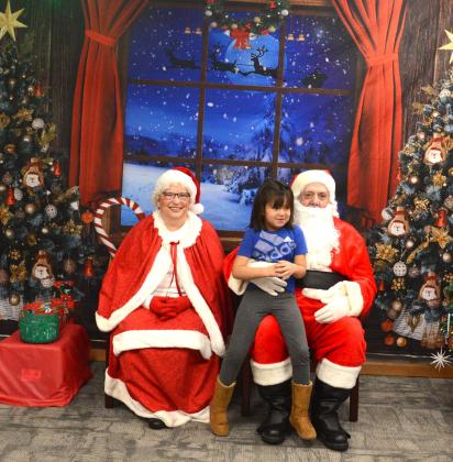 That heartwarming smile a child gets when they see Mr. and Mrs. Claus makes the chaos of the season stop for only a minute. Mr and Mrs. Claus made a stop into Waubay Santa Day. This event was full of family fun with carnival games and bingo, all with prizes the children could win. Pictured are Mr. and Mrs. Claus with Ismeala Strutz, who was pretty excited to see Santa and tell him what she wanted for Chirstmas. Reporter &amp;amp; Farmer | Jessica Washenberger