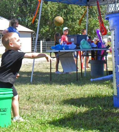 The Day County Fair was held Aug. 5-9 and many of Day County’s youth were there to be entertained. The fair was filled with countless activities, with one being a dunk tank where fairgoers dunked law enforcement. Here, Coy Pedersen is attempting to hit the target on the dunk tank. Reporter &amp; Farmer | Connor Handrahan