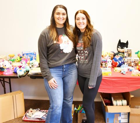 Chelsey Wood and Meagan Baumgarn hosted a free holiday clothing and toy drive at 708 Main St. Dec. 6-7. According to Wood, over eight boxes of donations were recieved from the community. Here from left, Wood and Baumgarn stand in front of a table with children’s toys donated for their drive Dec. 7. Reporter &amp;amp; Farmer | Brenner Cariveau