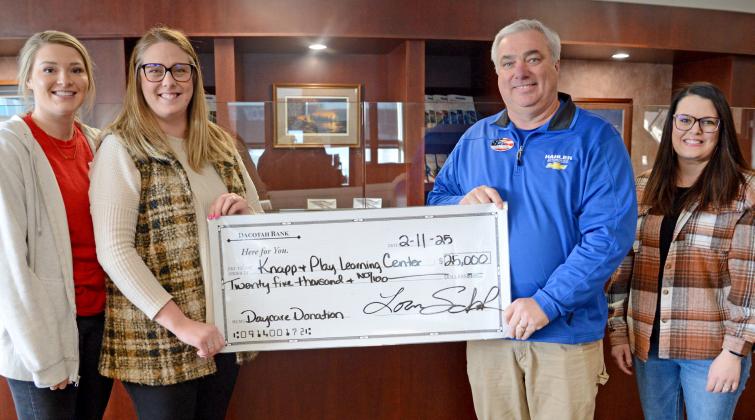 Lexi Rithmiller, Jenna Wik receive a check for $25,000 on behalf of the Knapp &amp;amp; Play Learning Center committee. The check was presented by Loren Shoenbeck, who gave the donation on behalf of himself and wife Lisa, from Dave Hahler Automotive. Also pictured is Rainy Hanson with the Webster Area Development Corporation. The presentation was made Feb. 11. Reporter &amp;amp; Farmer | Amanda Dulitz