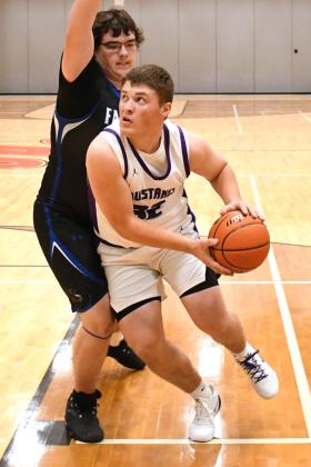 Tripp Gaikowski (32) of Waubay/Summit evades a defender during the Mustangs 63-35 win against Florence/ Henry Falcons Dec. 15 in Summit. Gaikowski aided the Mustangs with two points in the victory. Reporter &amp;amp; Farmer | Robert Dulitz