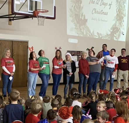 Webster Area Elementary School staff and students took part in a Christmas sing along in the elementary school gym Dec. 20. Staff, from left, leading the singing of The 12 Days of Christmas are Vanessa Bloom, Robin Dorsett, Jennifer Witt, Ashley Hanson, Christine Keller, Nancy Block, Heather Kwasniewski, Jared Vergeldt, Emily Wagner and Wade Rausch.