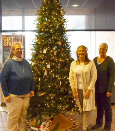 The Spirit of Christmas tree is giving joy to less fortunate children. Tags to donate presents for children can be found at Dacotah Bank, CorTrust Bank and First Interstate Bank in Webster. Here, from left volunteers Teresa Mikkelsen, Stacy Mount and Marla Althoff stand next to the Spirit of Christmas tree located in Dacotah Bank Dec. 4. Reporter &amp;amp; Farmer | Brenner Cariveau