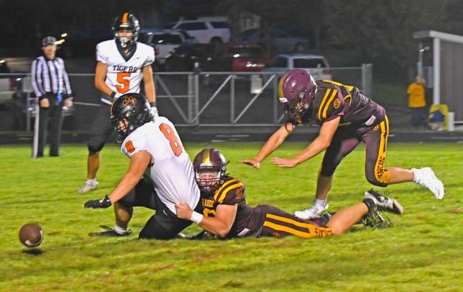 Matthew Mount (52) of Webster Area forces a fumble as he brings down Mobridge-Pollock Tigers running back Tyler Schmeichel (8) during the Bearcat’s 0-50 loss Sept. 19 in Webster. Statistics for the game were not provided in time for publishing. Reporter &amp;amp; Farmer | Amanda Dulitz