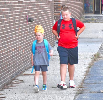 Webster Area School District had it’s first day of school Aug. 20. From left, Reuben Dale walks to the bus with his older brother Jacob Dale after finishing their first day. Reporter &amp;amp; Farmer | Connor Handrahan