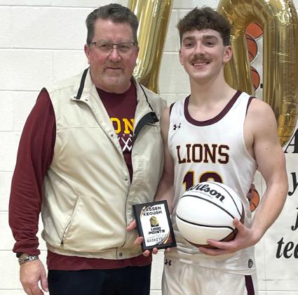 Langford Area senior Kassen Keough holds a plaque memorializing his 1,000th varsity basketball point, standing next to head basketball coach Brian Schuring following their game against Wilmot Wolves in Langford Jan. 3. Reporter &amp;amp; Farmer | Subscriber snapshot