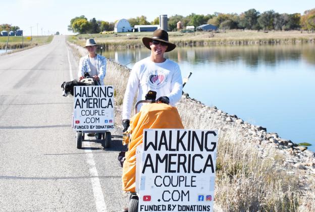 Torin and Paige Rouse walk with their dog Jak in their 12,000 mile journey which would result in them walking across every state. Here, the Rouse family walks just outside of Webster Oct. 7 as they prepared to finish up their trip in Watertown. Reporter &amp;amp; Farmer | Brenner Cariveau