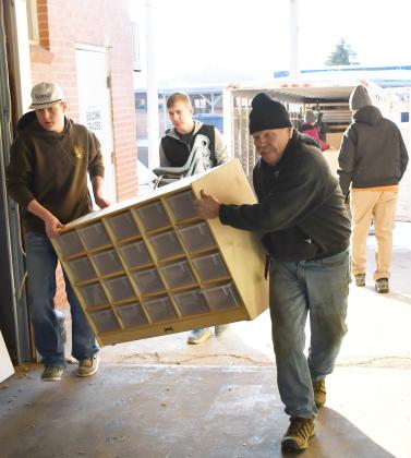 In order to renovate the Knapp &amp;amp; Play Learning Center building for a Webster day care, old furniture was being transported to the Lake Region Business Center Feb. 21 for storage. Here from left, Caleb Gaikowski, Gabriel Gaikowski and Nathan Meland haul a large organizer into a storage area. Reporter &amp;amp; Farmer | Brenner Cariveau