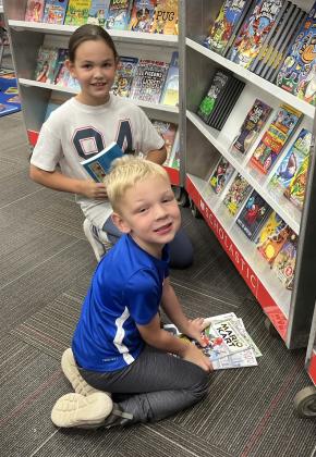 Webster Area held their book fair Oct. 5-8. Kids were able to go visit the school library all week long and purchase new and exciting stories for their entertainment. Here, Layla Nolte and her younger brother Jay Nolte enjoy looking through the book fair as their parents visit with their teachers. Reporter &amp; Farmer | Subscriber snapshot