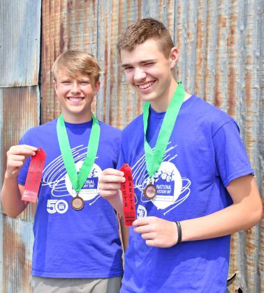 Jackson Baumgarn and Jase Voss smile as they hold ribbons they received from the National History Contest. The two traveled to Washington, DC to compete last month. Reporter &amp;amp; Farmer | Annie Witt