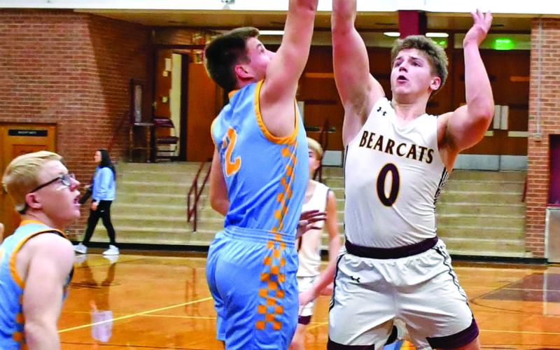 Webster Area Bearcats hosted the Hamlin Chargers Jan. 16 in a contest the Bearcats lost 22-71. Here, Tate Mammenga (0) attempts a floater over a pair of Hamlin defenders. Reporter &amp;amp; Farmer | Robert Dulitz