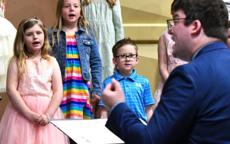 First graders Thea Sigdestad, Harlow Heupel and Leo Siemonsma perform during Webster Area School’s elementary spring concert April 24.