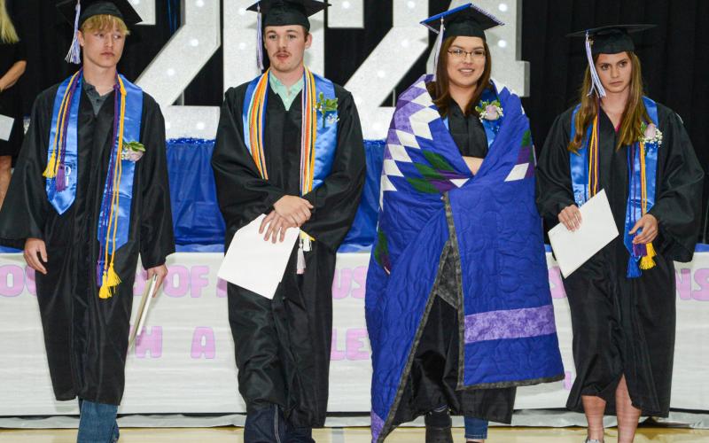 Members of the Class of 2024 from Waubay High School cross the school gym following the turning of their tassels at their graduation ceremony May 11. Pictured from left are Owen Niles, Caleb Weyh, Adryan Hopkins and Eva Benike. Reporter &amp;amp; Farmer | Amanda Dulitz