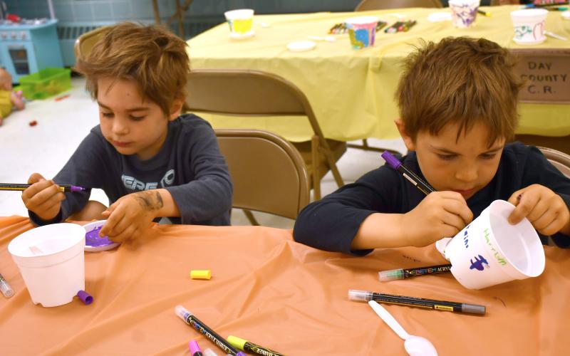 Reporter &amp;am Farmer | Annie Witt Brothers Jefferson and Harrison Fosheim decorate plant pots at the Mornings with Moms event which took place June 4 at the Day County Courthouse community room. Mornings with Moms is a group for parents and guardians of young children which facilitates meet-ups activities together. The group has a partnership with the Webster Public Library.