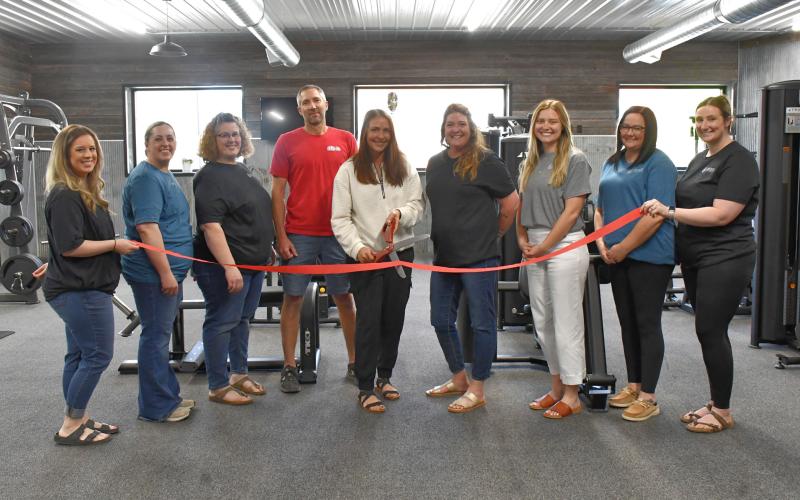 Reporter &amp;amp; Farmer | Leyton Beardslee Webster Area Chamber of Commerce members hold up a ceremonial ribbon to be cut by Fit Zone owner Jen Keller May 14. From left: Chamber members; Bailey Meyer, Alisha LaCourse and Amy Fischer; Owners Aaron and Jen Keller; Chamber members Katy Marx, Lindsey Olson, Tammy Eidahl and Lindsey Koenig.
