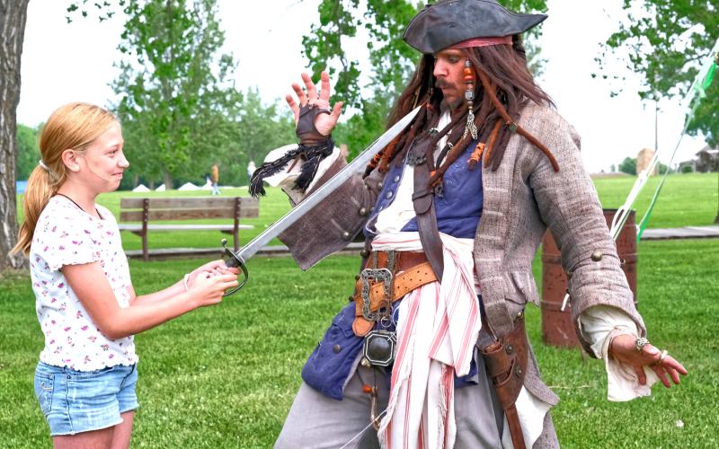 From left, Eva Schuelke pointed a sword at Joshua Godfredson portraying Jack Sparrow June 7 during Fort Sisseton Historical Festival at Fort Sisseton State Park. Godfredson gave a performance educating attendees on the history of pirates. Reporter &amp;amp; Farmer | Leyton Beardslee