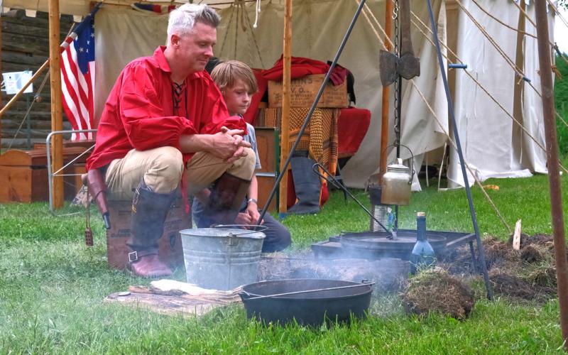 From left Aaron Grant and Aaron Grant Jr. watched their fire June 7 at Fort Sisseton Historical Festival. The annual festival saw its 47th year June 6-8. Reporter &amp;amp; Farmer | Leyton Beardslee