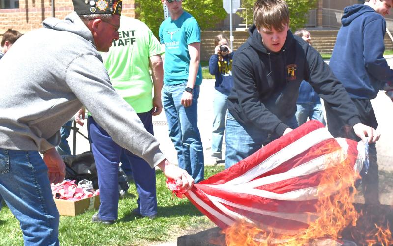 Webster Veterans of Foreign Wars (VFW) hosted a flag retirement at Webster Area School May 8. From left, Dan Kroll and Jacob Hoops participate in the ceremonial burning of the flags. Reporter &amp;amp; Farmer | Connor Handrahan