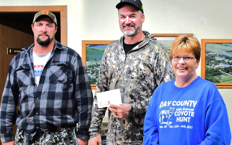 From left, Dale Peplinski and Joel Kaczynski are congratulated by Patti Mitchell for winning largest coyote. Peplinski and Kaczynski brought in a coyote that weighed 38.01 pounds for the Day County Coyote Hunt Dec. 14. Reporter &amp;amp; Farmer | Connor Handrahan